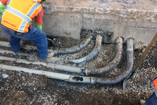 Jacobsen Construction Co. associates work around four conduits discovered during ACC excavation.  [Photo: Tim Goodale]