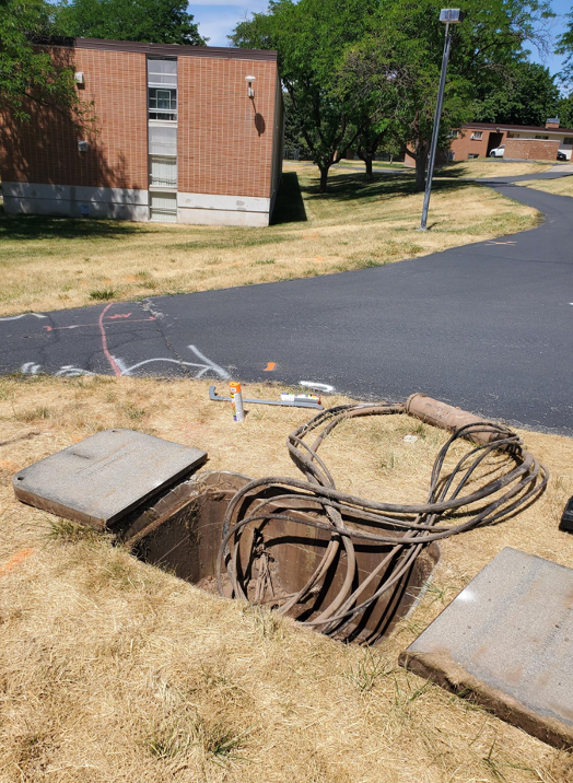 The UIT Cable Plant team spent long days at the height of summer locating the West Village's original cabling (photo courtesy of Tim Goodale).