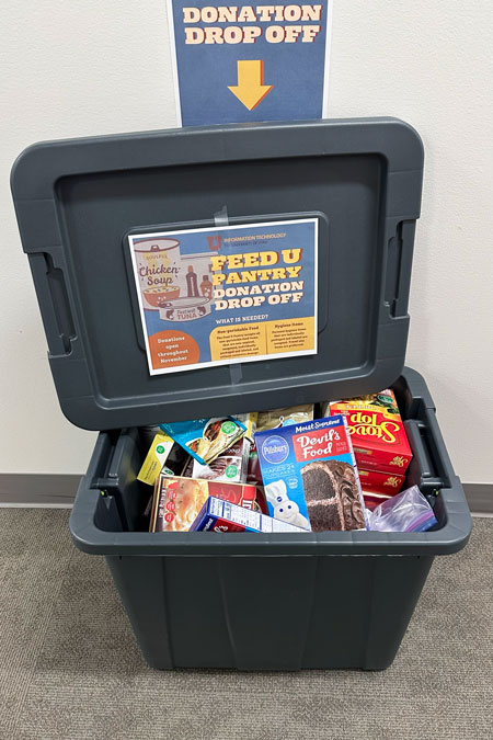 A 30 gallon tote filled to the brim with donations.