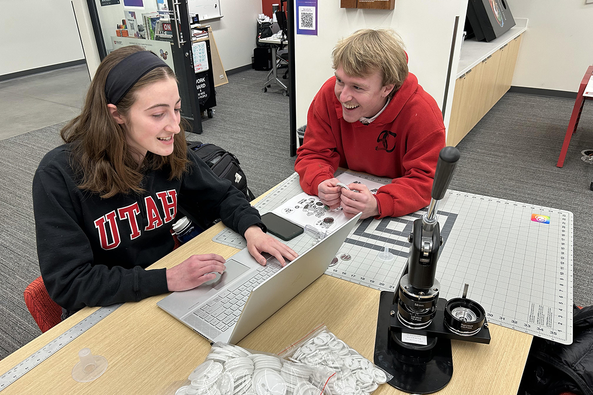 Adobe Creative Consultants Olivia Etz, left, and Canyon Sargent speak with each other at Adobe Creative Commons in Kahlert Village on January 17, 2025.