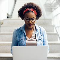 Stock image of a young person with a laptop computer