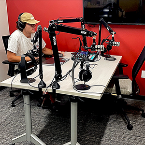 Drew Dennison, Adobe creative consultant, uses a new podcast studio in Kahlert Village. Image courtesy of Tony Sams.