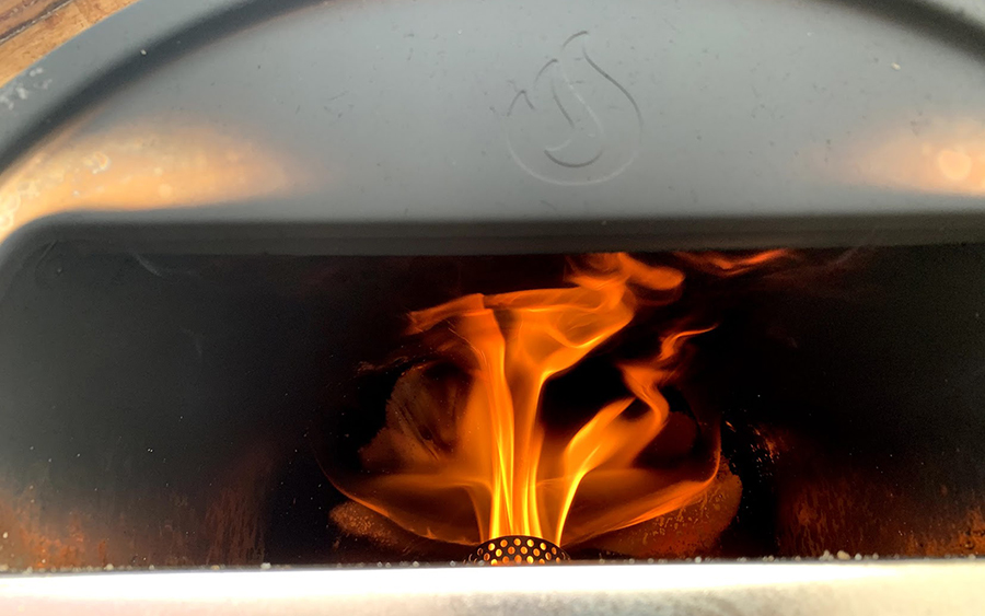 Flames inside a pizza oven that Harris created during the pandemic.