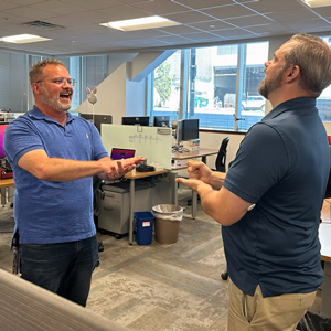 Brandon Gresham (left) and Rob Lake play Rock, Paper, Scissors.