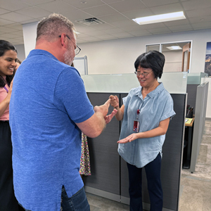 Brandon Gresham (left) and Lihong Yu play Rock, Paper, Scissors.