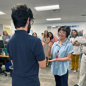 Ari Lacanienta (left) and Lihong Yu play Rock, Paper, Scissors.