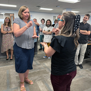 Suzanne Wayment (left) and Emily Jacoby play Rock, Paper, Scissors.