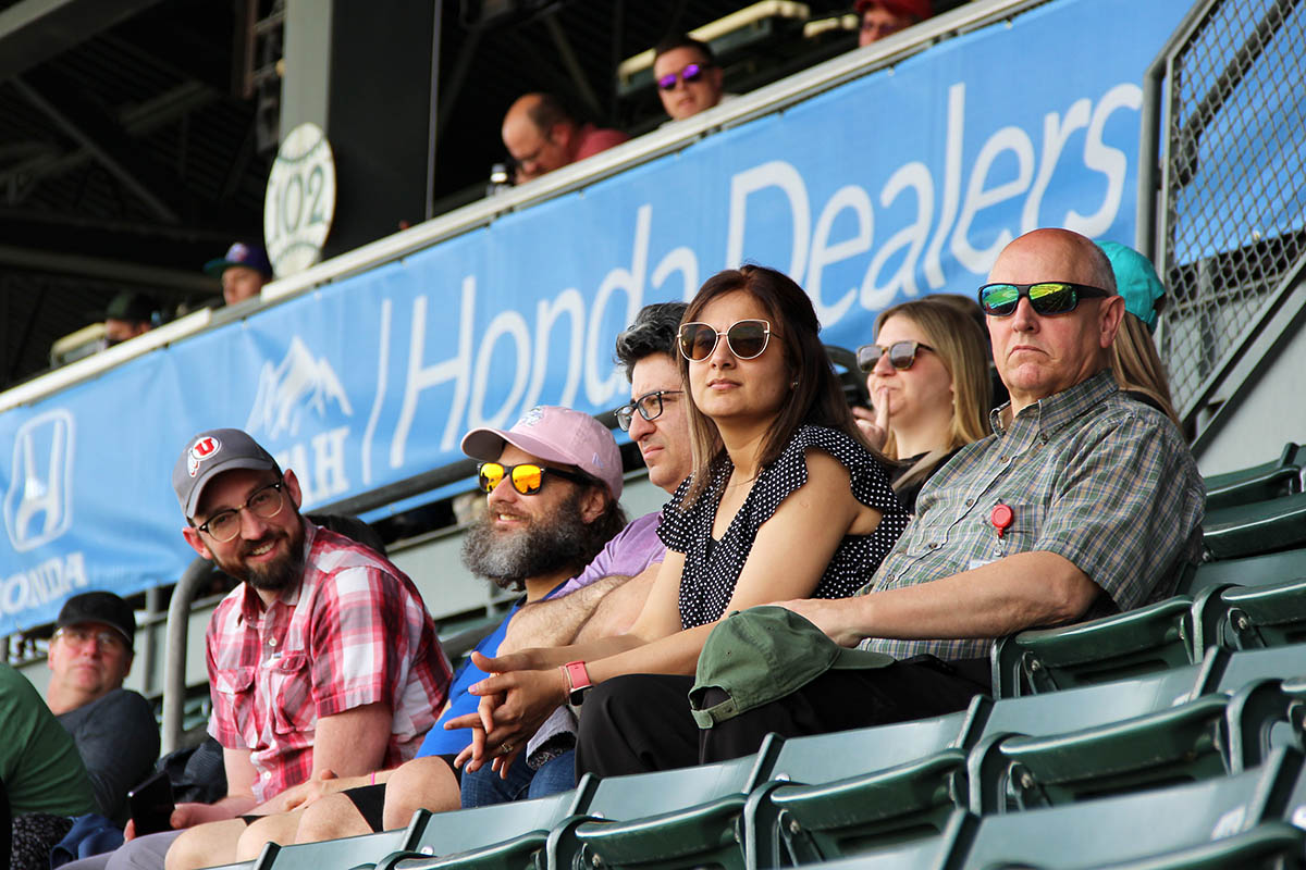 UIT employees watch the ballgame from their seats in the stands.