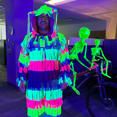 Data Management & Analytics (DMA) Director Brian Harris, dressed as a “Pedaling Piñata,” won best costume, while DMA won best decorated area with “Haunted Pumpkin Patch.” (Courtesy of Abbey Allen)