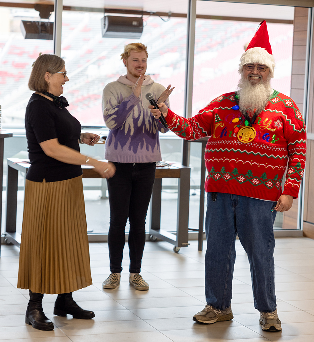 L-R: Holly K. Johnson, Jareth Archer, and Warren Malupo, winner of the festive sweater contest 