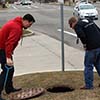 Johnson removes the manhole cover.