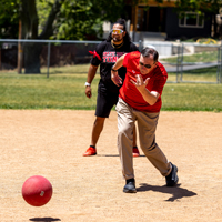 DCIO Ken Pink, foreground, pitches for the USS team, while Monty Kaufusi (CTO) looks on. (Photo by Thanh Nguyen)