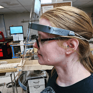 Beth Sallay models a face shield that her team 3D printed and laser cut at Make Salt Lake as part of its COVID-19 PPE project. (Courtesy of Beth Sallay)